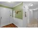 Entryway featuring hardwood floors, coat rack, and a white front door leading to the home's interior at 8605 Ducksbill Dr, Charlotte, NC 28277