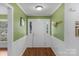 Welcoming front foyer with hardwood floors and a white front door at 8605 Ducksbill Dr, Charlotte, NC 28277