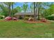A well-maintained lawn and colorful azaleas enhance this home's curb appeal at 8605 Ducksbill Dr, Charlotte, NC 28277