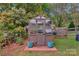Charming greenhouse surrounded by lush greenery and vibrant plants, perfect for gardening enthusiasts at 8605 Ducksbill Dr, Charlotte, NC 28277