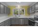 Bright kitchen features stainless steel dishwasher, lots of cabinet space and natural light at 8605 Ducksbill Dr, Charlotte, NC 28277