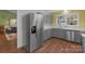 Bright kitchen with stainless steel appliances, gray cabinets and hardwood floors at 8605 Ducksbill Dr, Charlotte, NC 28277