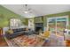 Bright living room with a cozy fireplace, colorful rug, and sliding glass doors to the backyard patio at 8605 Ducksbill Dr, Charlotte, NC 28277