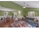 Open living room with hardwood floors, complemented by a dining area and bright green walls at 8605 Ducksbill Dr, Charlotte, NC 28277