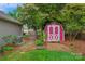Charming backyard shed with brick path, mature shrubs and established landscaping at 8605 Ducksbill Dr, Charlotte, NC 28277