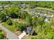 Aerial view highlighting a home with mature trees and the neighborhood's pleasant setting at 869 Kathryn Se Dr, Concord, NC 28025