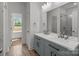 Bathroom with double vanity, framed mirror, and glass shower door at 869 Kathryn Se Dr, Concord, NC 28025