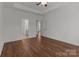 Spacious bedroom featuring wood floors, neutral paint, and a lighted ceiling fan at 869 Kathryn Se Dr, Concord, NC 28025