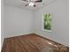 Bright bedroom featuring wood-look floors and a window looking out to the trees at 869 Kathryn Se Dr, Concord, NC 28025