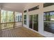 Spacious covered deck with wood floors and views of the surrounding trees at 869 Kathryn Se Dr, Concord, NC 28025
