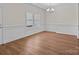 Dining area showcases hardwood floors, a large window, chandelier and detailed trim work at 869 Kathryn Se Dr, Concord, NC 28025