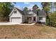 Charming home featuring a white exterior, covered porch, attached garage, and well-manicured lawn at 869 Kathryn Se Dr, Concord, NC 28025