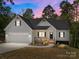 Charming home with a front porch, two-car garage, manicured landscaping and eye-catching colors at 869 Kathryn Se Dr, Concord, NC 28025