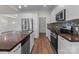 Open kitchen area with stainless steel appliances, kitchen island, wood countertop and mosaic backsplash at 869 Kathryn Se Dr, Concord, NC 28025