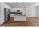 Modern kitchen with stainless steel appliances, kitchen island, and mosaic backsplash at 869 Kathryn Se Dr, Concord, NC 28025