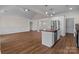 Open kitchen and living space with stainless appliances, an island, and modern finishes at 869 Kathryn Se Dr, Concord, NC 28025