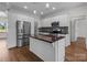 Modern kitchen with stainless steel appliances, kitchen island, and mosaic backsplash at 869 Kathryn Se Dr, Concord, NC 28025