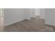 This is a spacious living room that features luxury vinyl plank flooring and baseboard molding throughout at 869 Kathryn Se Dr, Concord, NC 28025