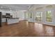 Open concept living and kitchen area featuring hardwood floors, large windows, and access to the deck at 869 Kathryn Se Dr, Concord, NC 28025