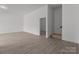 Open-concept living room with hardwood floors and staircase to the upper level at 869 Kathryn Se Dr, Concord, NC 28025