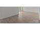 A simple living room features hard surface floors and a sliding glass door to the yard at 869 Kathryn Se Dr, Concord, NC 28025