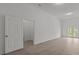 Spacious living room with luxury vinyl plank flooring, white trim, natural light, and French doors to the outside at 869 Kathryn Se Dr, Concord, NC 28025