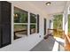 Cozy covered porch with wood railing, offering a welcoming entrance to the home with natural light at 869 Kathryn Se Dr, Concord, NC 28025
