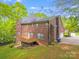 Enjoy a spacious backyard with a wooden deck and mature trees surrounding the property at 1000 Potters Bluff Rd, Monroe, NC 28110