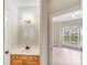 Bathroom with vanity, wood cabinets, decorative mirror, and an adjacent room at 1000 Potters Bluff Rd, Monroe, NC 28110