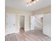 Bedroom with light wood flooring and views of the staircase and foyer at 1000 Potters Bluff Rd, Monroe, NC 28110