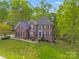 Beautiful two-story brick home with lush landscaping and a welcoming front entrance at 1000 Potters Bluff Rd, Monroe, NC 28110