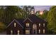 Beautiful two-story brick home with lush landscaping and a welcoming front entrance at dusk at 1000 Potters Bluff Rd, Monroe, NC 28110