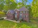 Beautiful two-story brick home with lush landscaping and a welcoming front entrance at 1000 Potters Bluff Rd, Monroe, NC 28110