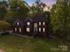 Beautiful two-story brick home with lush landscaping and a welcoming front entrance at dusk at 1000 Potters Bluff Rd, Monroe, NC 28110