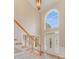 Bright foyer features a staircase, beautiful chandelier, arched window, and front door with decorative glass at 1000 Potters Bluff Rd, Monroe, NC 28110