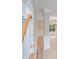 Hallway featuring wood floors and decorative wainscoting leading to a living area with a window and chandelier at 1000 Potters Bluff Rd, Monroe, NC 28110