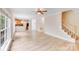 Living room featuring hardwood floors and view into kitchen and staircase at 1000 Potters Bluff Rd, Monroe, NC 28110
