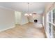 Spacious living room featuring light wood floors, a fireplace, and crown molding at 1000 Potters Bluff Rd, Monroe, NC 28110