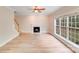 Spacious living room featuring a fireplace, staircase, and large windows at 1000 Potters Bluff Rd, Monroe, NC 28110