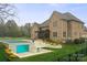 Luxurious backyard featuring a modern pool with clear glass and a covered outdoor living area at 1012 Harper Lee Dr, Newton, NC 28658
