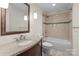 Bathroom featuring granite counters, undermount sink, tile floors, and shower over tub at 1012 Harper Lee Dr, Newton, NC 28658