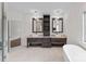 This bathroom features double sinks, dark wood vanity and a standalone tub at 1012 Harper Lee Dr, Newton, NC 28658