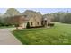 Aerial view of a brick home with mature landscaping and a long driveway at 1012 Harper Lee Dr, Newton, NC 28658