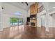 Bright, open living room boasts a vaulted ceiling, stone fireplace, and expansive views of the outdoor pool at 1012 Harper Lee Dr, Newton, NC 28658