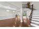 Expansive living room featuring an open floor plan with staircase and views of the backyard pool at 1012 Harper Lee Dr, Newton, NC 28658