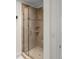 Beautiful shower with tile surround, glass door, and built-in shelves, blending style with functionality at 1012 Harper Lee Dr, Newton, NC 28658