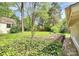 Landscaped backyard featuring a retaining wall and a variety of plants and shrubbery at 10432 Camelback Cir, Charlotte, NC 28226
