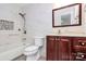 Bathroom featuring tiled walls, a white toilet, and a vanity with a wood finish at 10432 Camelback Cir, Charlotte, NC 28226