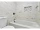 Modern bathroom features marble tile, a bathtub with a mosaic tile niche, and a sleek faucet at 10432 Camelback Cir, Charlotte, NC 28226