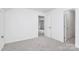 This upstairs bedroom has new carpet, a ceiling fan and two doors at 10432 Camelback Cir, Charlotte, NC 28226